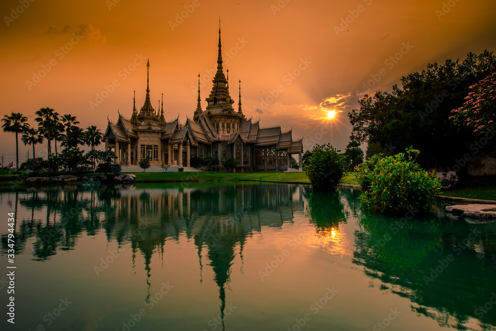 Fototapeta premium Wallpaper Wat Lan Boon Mahawihan Somdet Phra Buddhacharn(Wat Non Kum)is the beauty of the church that reflects the surface of the water, popular tourists come to make merit and take a public photo