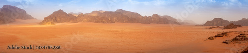 Panorama wide angle of an empty Wadi Rum desert in spring, with some clouds in the air. © Kristof