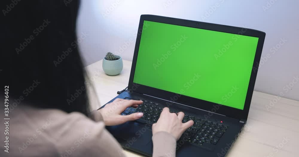Over the shoulder shot of young girl looking at green screen Over the shoulder shot of young girl looking at green screen