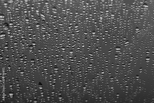 Water drops on gray background, top view