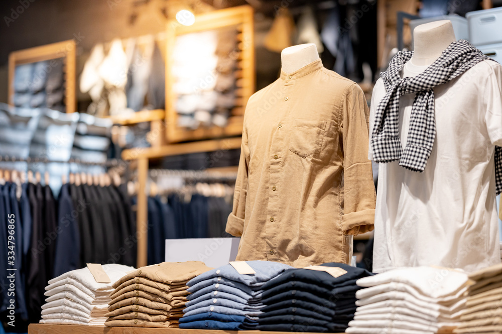 Trendy cotton Men shirt display on mannequin in clothes shop. Summer  collection fashion product samples in clothing store for selling. Textile  industry and business concept Stock Photo