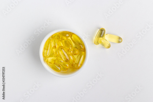 yellow gel pills on white background
