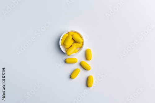 yellow pills on white background