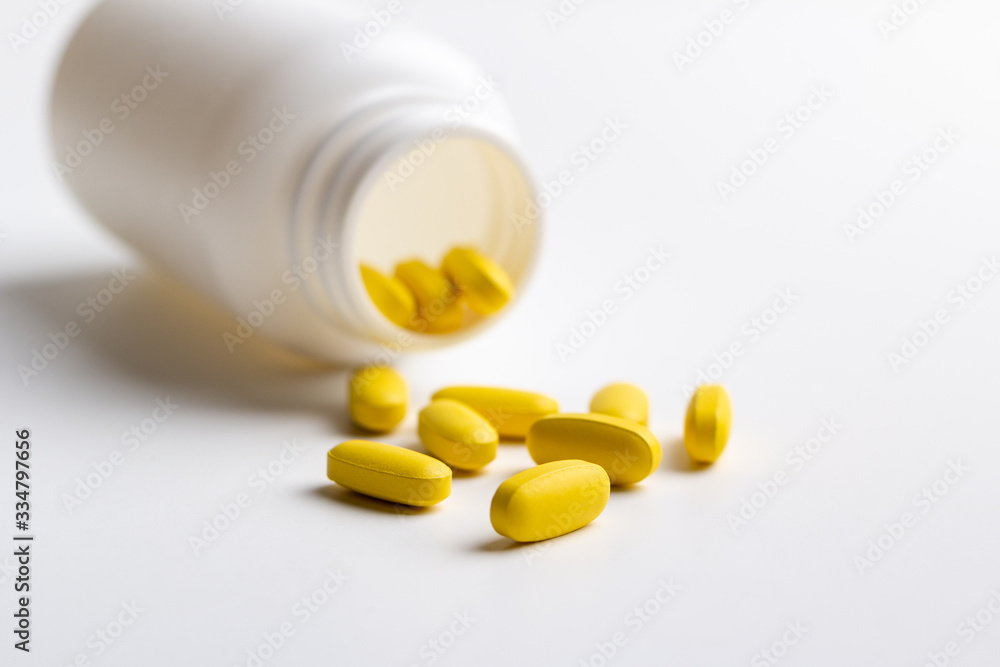 pills and bottle on white background pills and bottle on white background