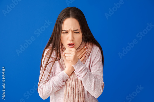 Coughing young woman on col...
