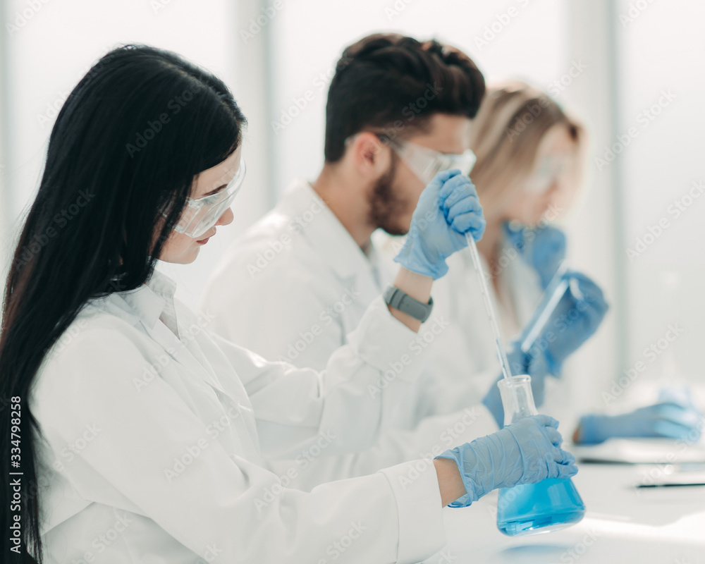close up.modern woman sitting with colleagues at the laboratory