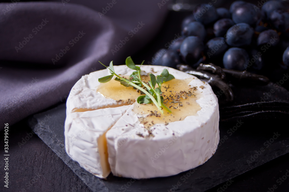 Camembert brie and mozarella cheese with honey and herbs. Dairy products.