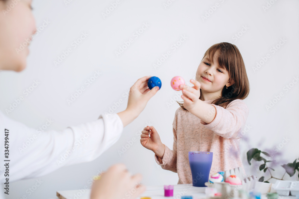 Happy Easter concept. Family preparing for Easter celebration. Art and craft concept with female hands and paiting eggs by girls Happy Easter concept. Family preparing for Easter celebration. Art and craft concept with female hands and paiting eggs by girls