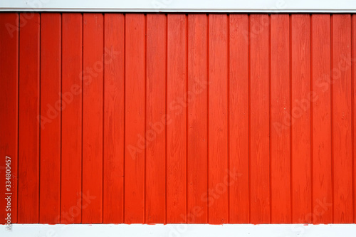 Old wooden background painted with red paint with a texture of cracks and scratches. Red background photo