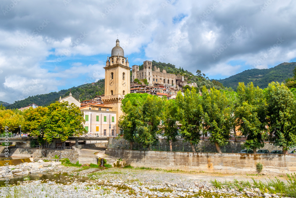 The Church of Sant'Antonio Abate with the ancient hilltop castle in the medieval village of Dolceacqua, Italy, near the Ligurian coast of Italy.