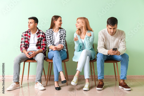 Young people waiting in lin...