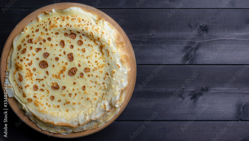 Fresh pancakes on a wooden background Fresh pancakes on a wooden background