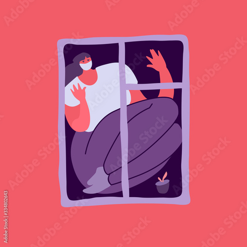 Self-isolation, lockdown depression, loneliness. Woman looking through a window during the coronavirus quarantine. The girl staying home, sitting on a windowsill, looks at the outside.