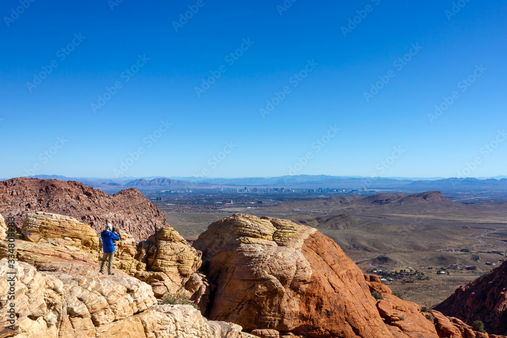 Fototapeta premium Las Vegas view man tourist backpacker red rock mountains landscape Red Rock Canyon National Conservation Area Nevada’s Mojave Desert