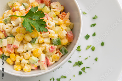 crab sticks salad with sweet corn, cucumber, bell pepper, and egg dressed with mayonnaise