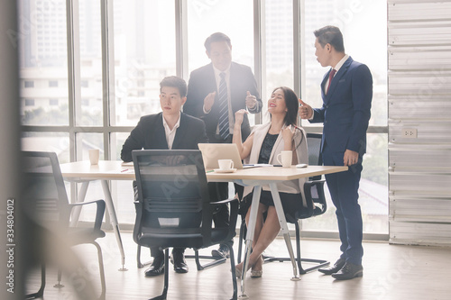 business team Asian congratulating Colleague