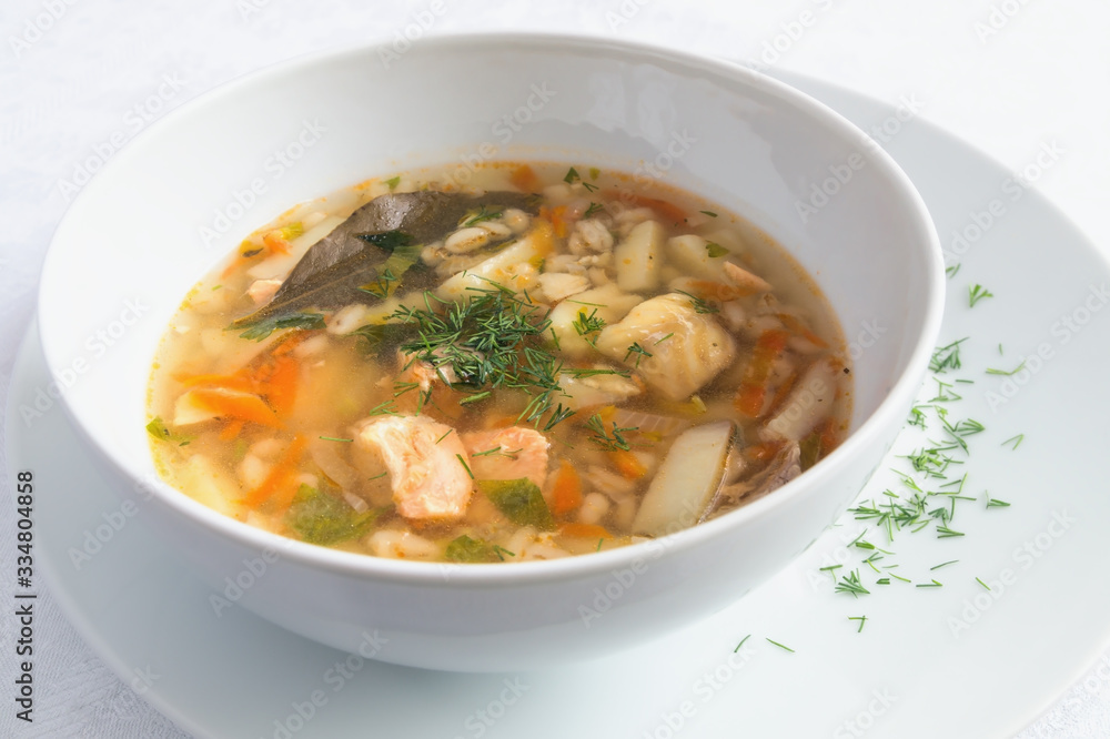 a bowl of cod and salmon soup decorated with dill a bowl of cod and salmon soup decorated with dill