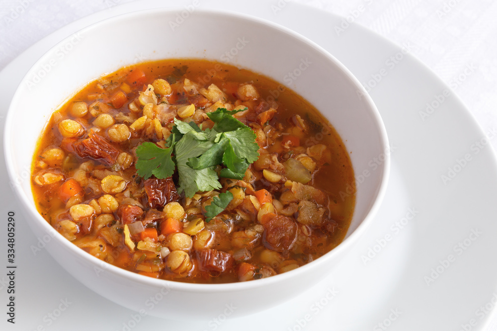 a bowl of pea soup vegetables decorated with cilantro leafs a bowl of pea soup vegetables decorated with cilantro leafs