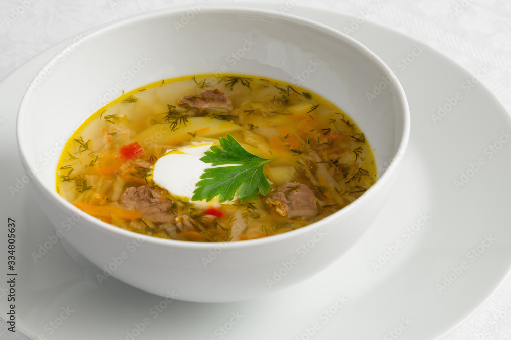 cabbage soup with sour cream decorated with parsley leaf cabbage soup with sour cream decorated with parsley leaf