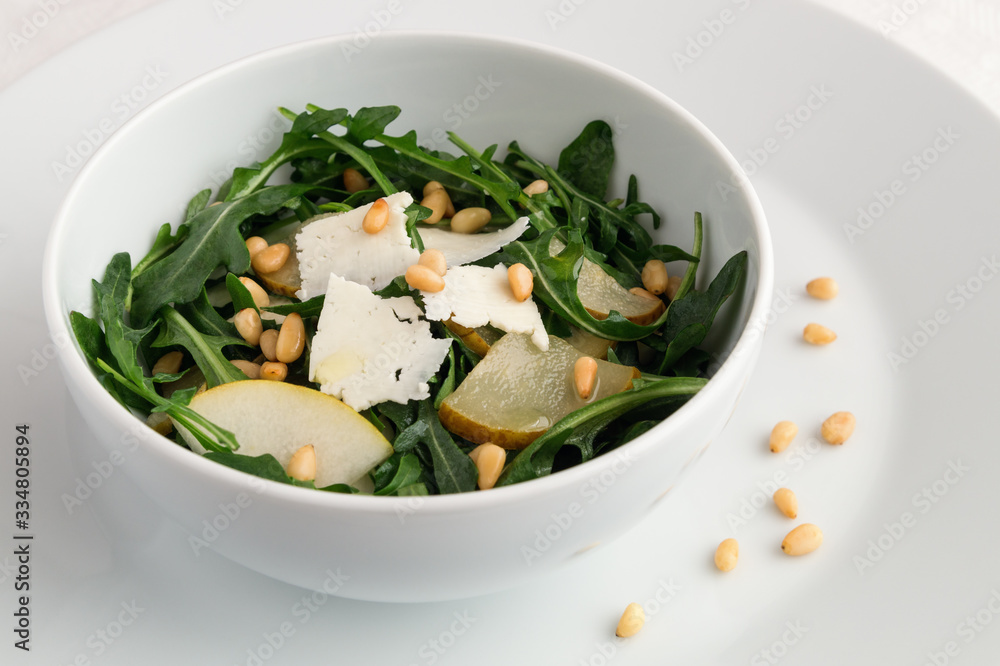 honey poached pear arugula salad with bryndza cheese and pine nuts dressed with white wine vinegar and oil honey poached pear arugula salad with bryndza cheese and pine nuts dressed with white wine vinegar and oil