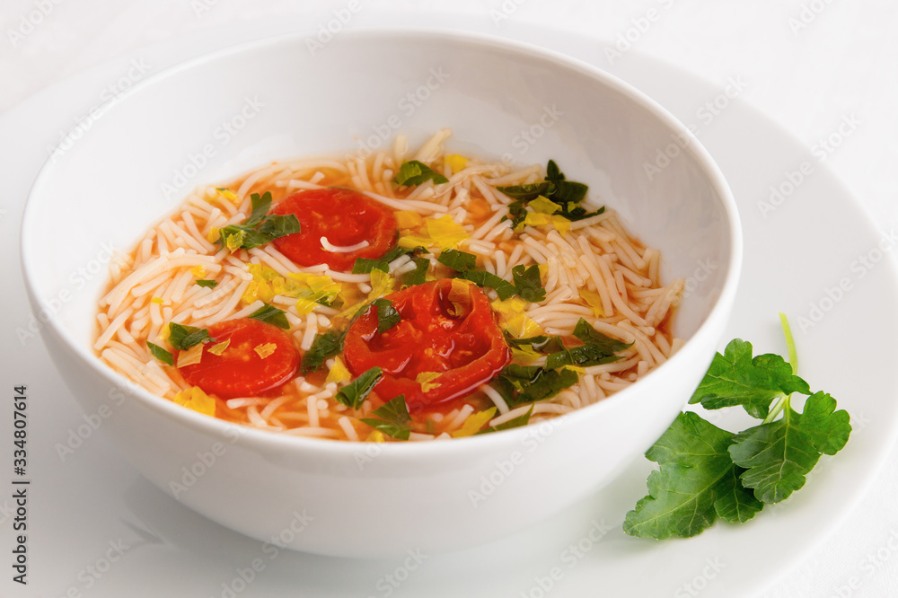a bowl of tomato soup with vermicelli a bowl of tomato soup with vermicelli