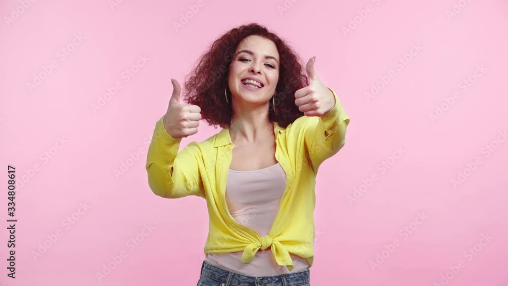 excited, happy girl showing thumbs up and smiling at camera isolated on pink excited, happy girl showing thumbs up and smiling at camera isolated on pink