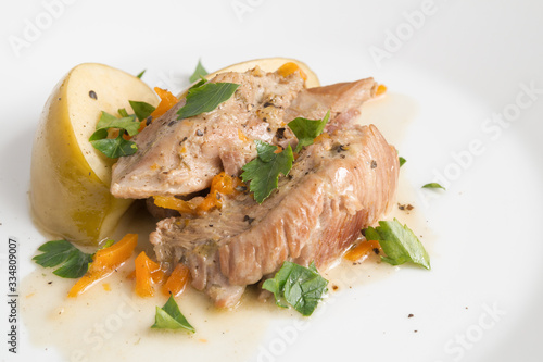 turkey chops stewed with vegetables and apples decorated with parsley