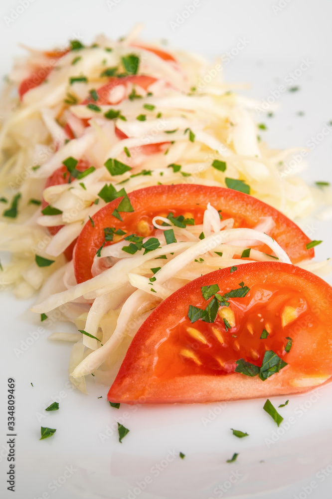 bright salad with tomatoes and white cabbage sprinkled with parsley bright salad with tomatoes and white cabbage sprinkled with parsley