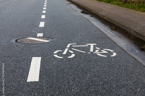 bicycle lane sign on road with wrongly turned stoke
