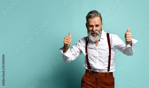 Senior hipster man with elegant suit on a blue background - young fashionable adult having fun