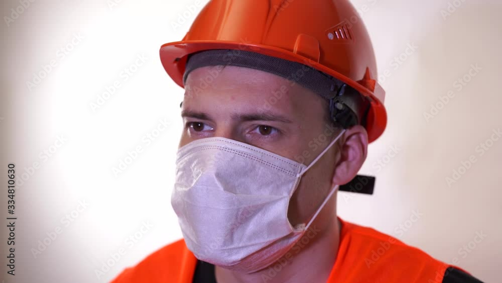 Portrait of young man in medical mask on his face on white background. Adult male covered face with mask to protect yourself from diseases. Concept of coronavirus epidemic or diseases. Portrait of young man in medical mask on his face on white background. Adult male covered face with mask to protect yourself from diseases. Concept of coronavirus epidemic or diseases.