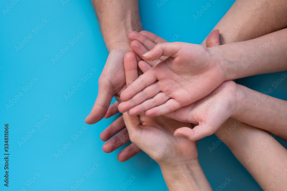 Family holding empty hands on blue background. Top view Family holding empty hands on blue background. Top view