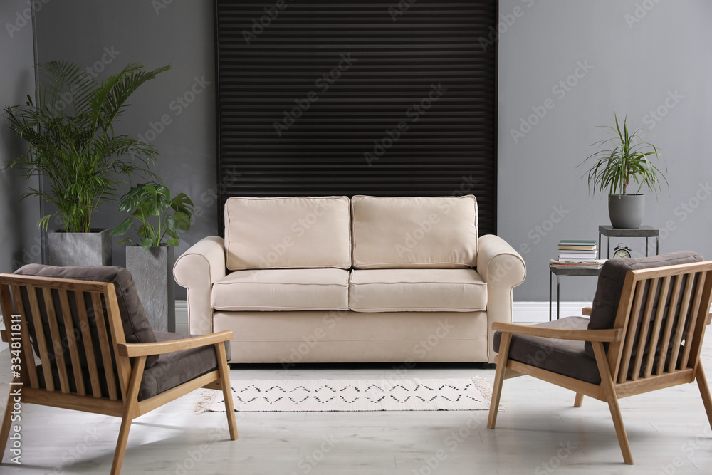 Fototapeta premium Stylish living room interior with comfortable sofa and armchairs