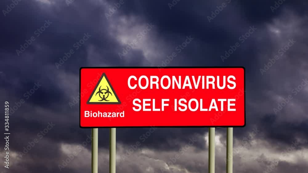A red road sign warning of the biohazard Coronavirus Covid-19 virus infection and illness with stay at home advice under a time lapse of gathering dark storm clouds. Lockdown and self isolation. A red road sign warning of the biohazard Coronavirus Covid-19 virus infection and illness with stay at home advice under a time lapse of gathering dark storm clouds. Lockdown and self isolation.