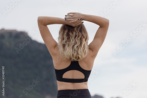 Fitness concept. Backview portrait of a fit female in black outf photo