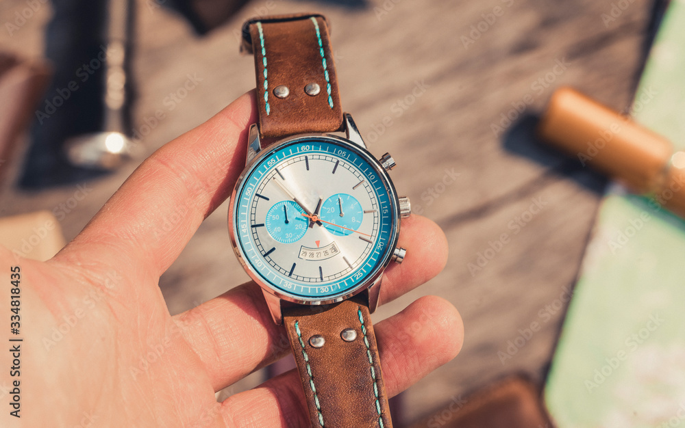 watch in hand. Wooden background. watch in hand. Wooden background.