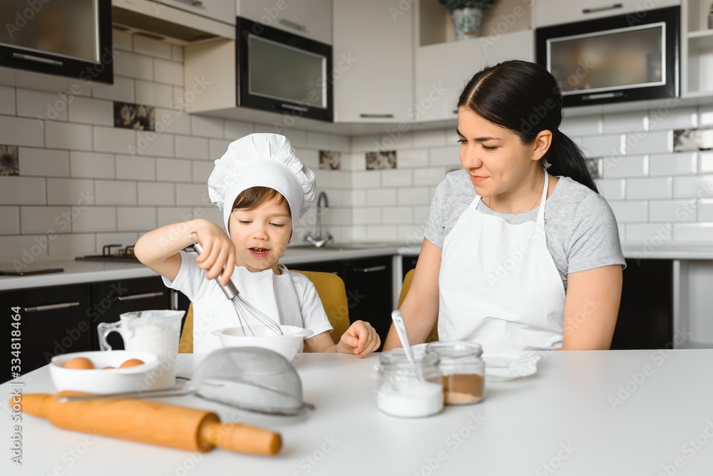Smiling mother and son having fun in the kitchen Smiling mother and son having fun in the kitchen