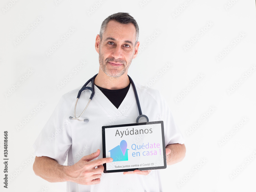 Handsome middle aged male doctor points out an advice written in spanish on his tablet : Handsome middle aged male doctor points out an advice written in spanish on his tablet :