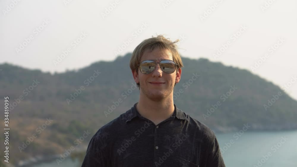 Portrait of Handsome Young Tourist Man Wearing Sunglasses on Tropic Island Portrait of Handsome Young Tourist Man Wearing Sunglasses on Tropic Island