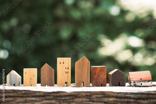 House model on wood table. Real estate agent offer house, property insurance and security, affordable housing concepts photo