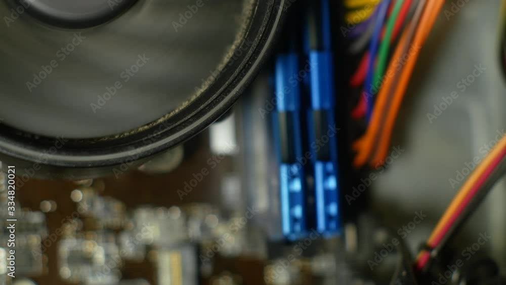 CPU fan close up. A very dirty CPU cooler starts spinning and then