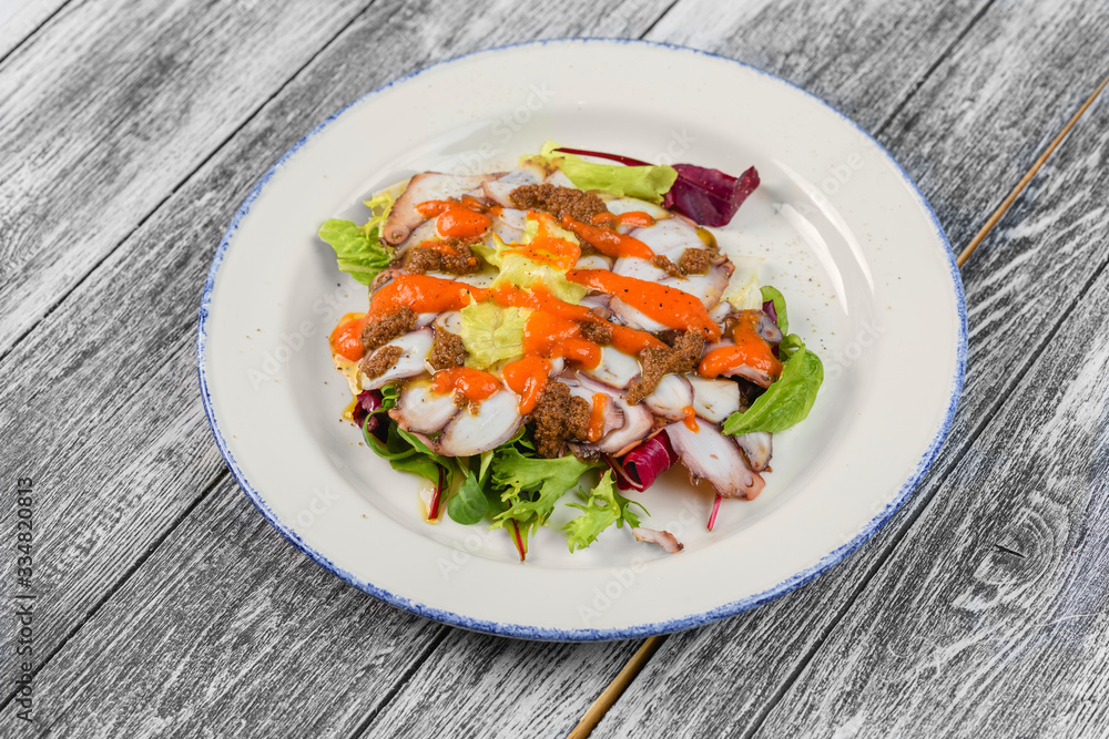 With seafood salad in plate on wooden background With seafood salad in plate on wooden background