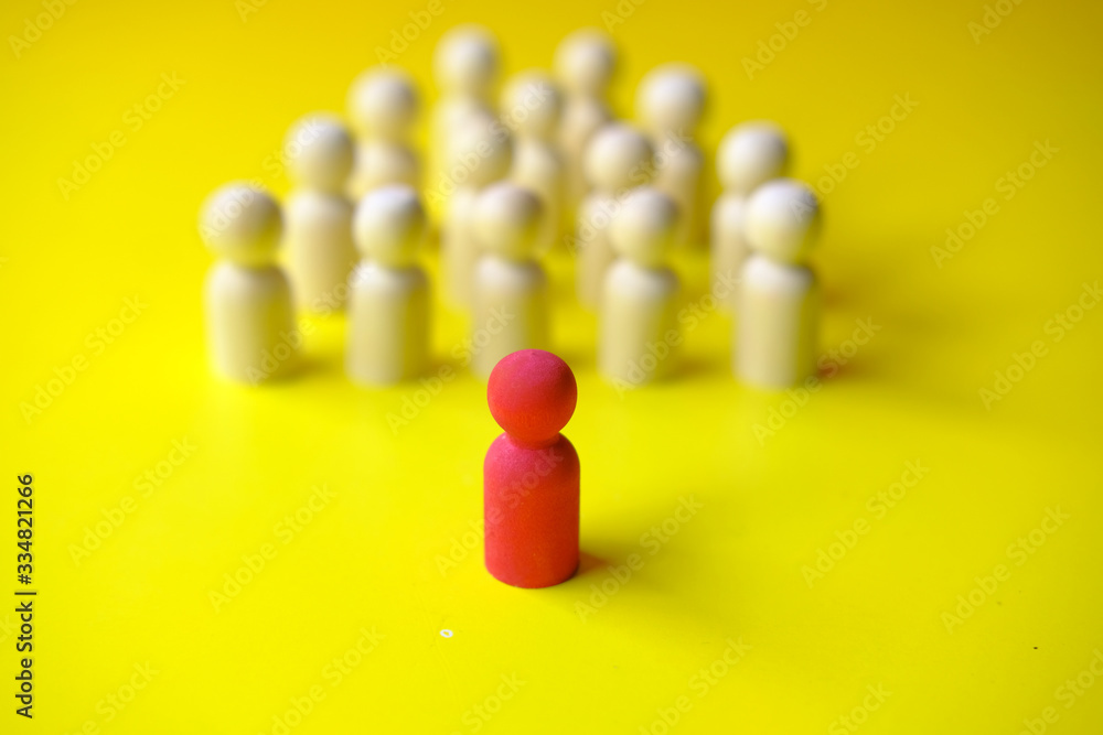 A stick wood block standing in front of a group of round wood block. A stick wood block standing in front of a group of round wood block.