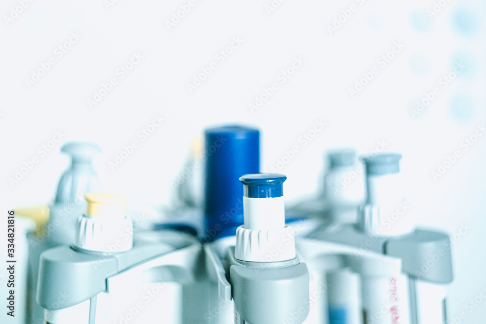 Laboratory pipettes on blurred laboratory background. Research and development concept with free space for text.