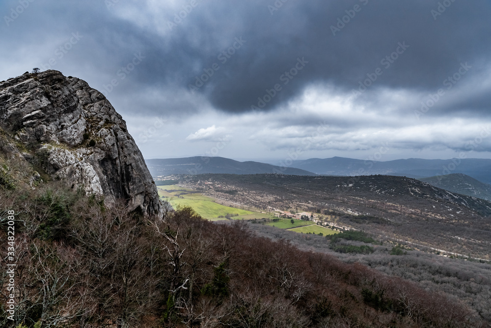 The mountain over grotto of Mary Magdalene at cloudy weather, clouds over a valley, a dry grass