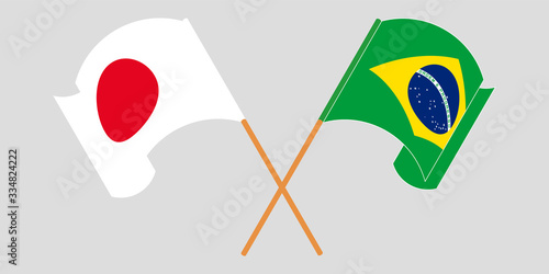 Crossed and waving flags of Brazil and Japan