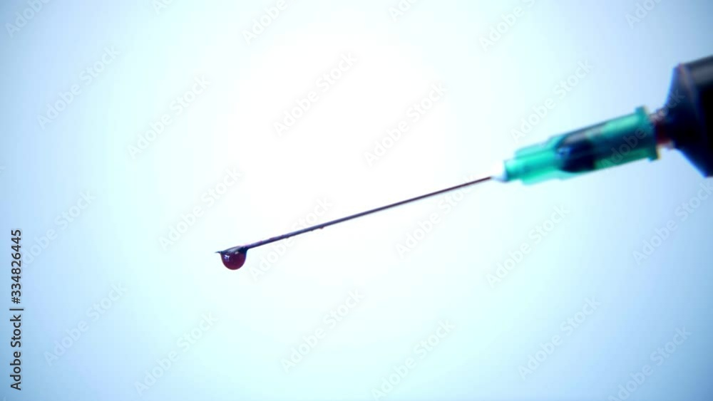 Macro shot of a syringe taking blood for analysis Macro shot of a syringe taking blood for analysis