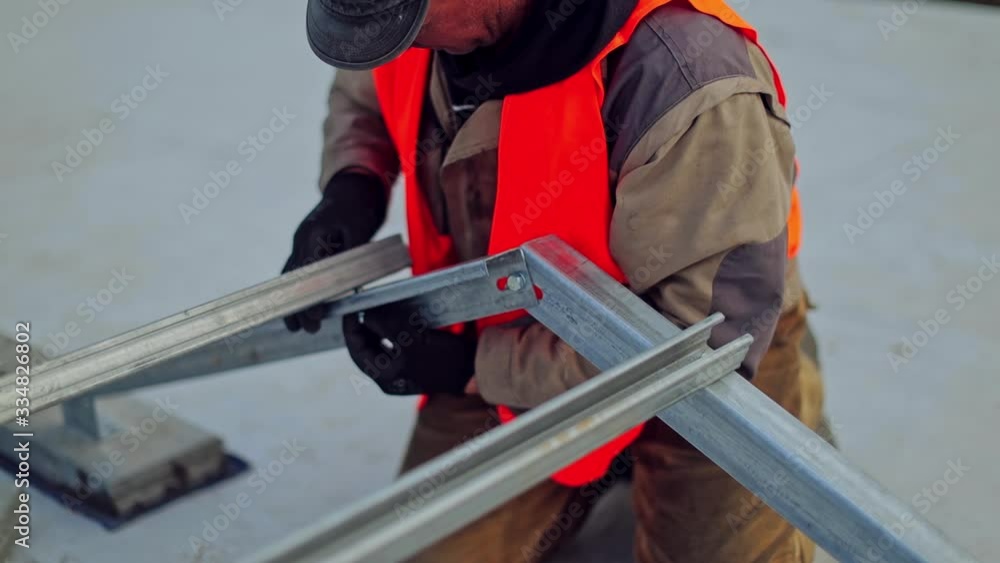Solar power plant. Fitting solar panels to roof of building Solar power plant. Fitting solar panels to roof of building