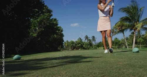Athletic Woman driving golf ball
