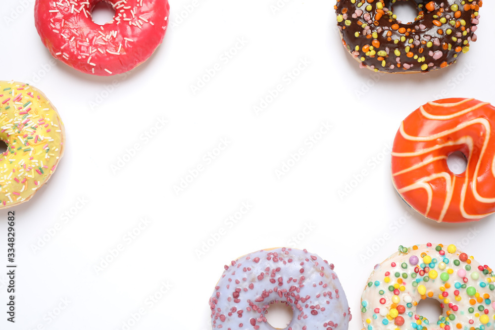 Delicious glazed donuts on white background, flat lay. Space for text Delicious glazed donuts on white background, flat lay. Space for text